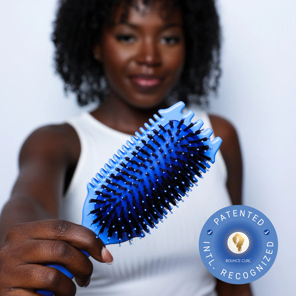 Bounce Curl Volume EdgeLift Brush - lifestyle shot in use on curly hair